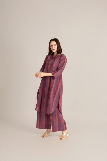 Woman wearing a striped dress with a plain background
