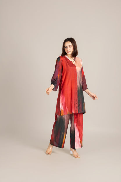 Woman wearing a red and black patterned outfit on a beige background