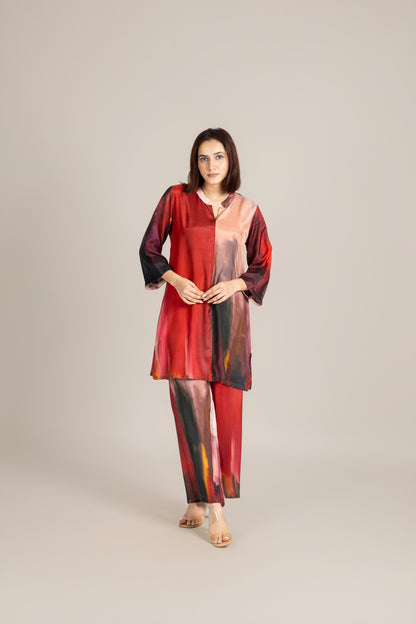 Woman wearing a red and black patterned outfit on a beige background