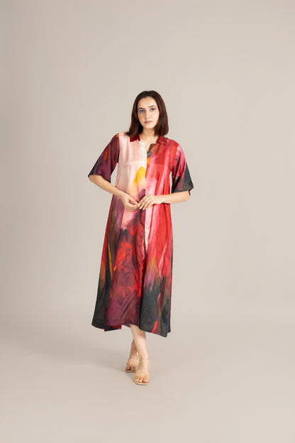 Woman wearing a colorful dress with abstract patterns on a plain background