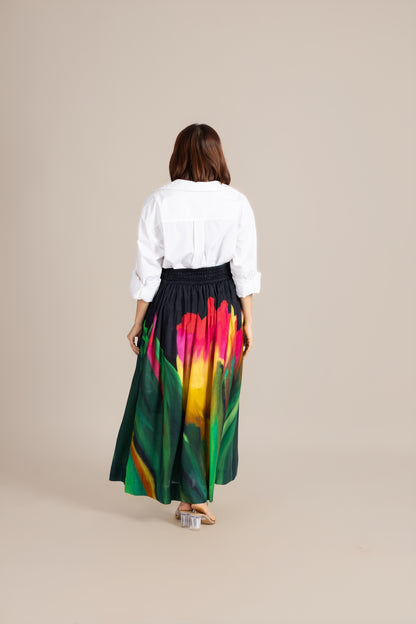 Woman wearing a colorful skirt with a white background