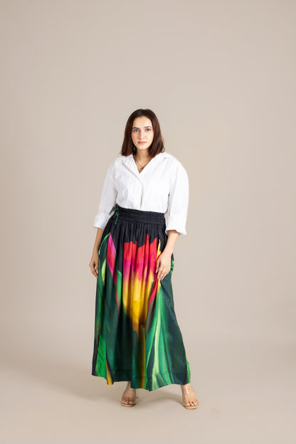 Woman wearing a white blouse and colorful skirt on a beige background