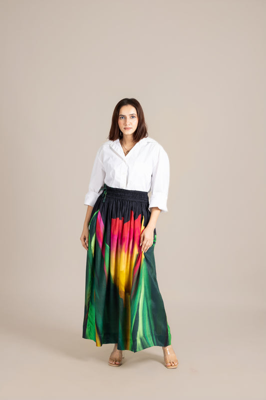Woman wearing a white blouse and colorful skirt on a beige background