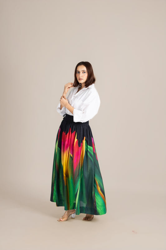 Woman wearing a white blouse and colorful skirt on a beige background