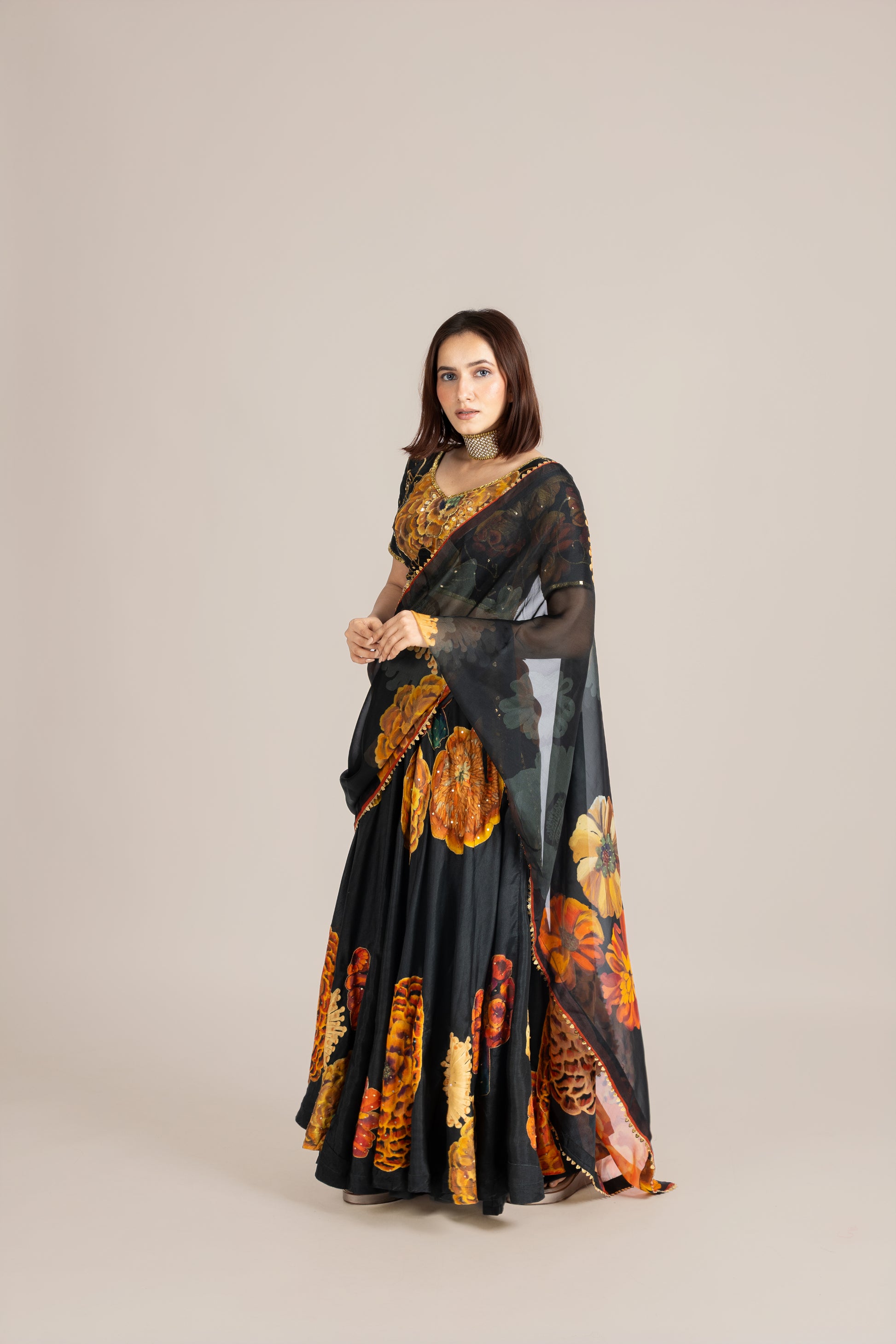 Woman wearing a black floral dress on a beige background